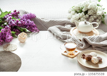 Cozy spring composition with tea and blooming lilac. 135875539