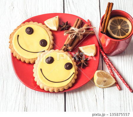 Cup of hot tea with lemon and cookies Cup of hot tea with lemon and cookies 135875557