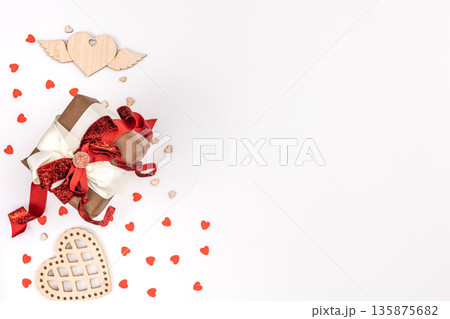 Flat lay, white background with gift box and valentine's day decor details. 135875682