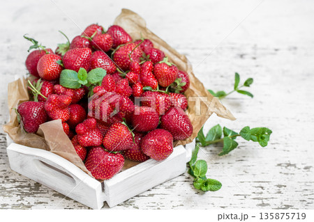 Fresh strawberries on a wooden tray Fresh strawberries on a wooden tray 135875719