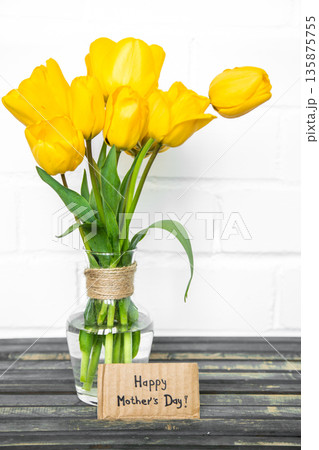 postcard Mother's Day and yellow tulips on wooden background postcard Mother's Day and yellow tulips on wooden background 135875755