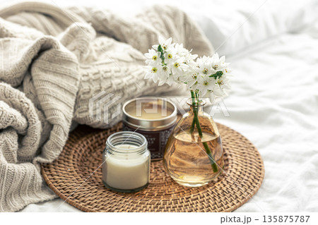Home composition with flowers in vases and a knitted element. Home composition with flowers in vases and a knitted element. 135875787