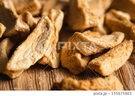 Homemade dried organic apple sliced on wood background. Homemade dried organic apple sliced on wood background. 135875803