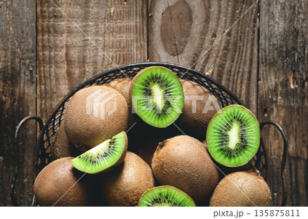 Kiwi fruits on a wooden background, a view of the top. 135875811