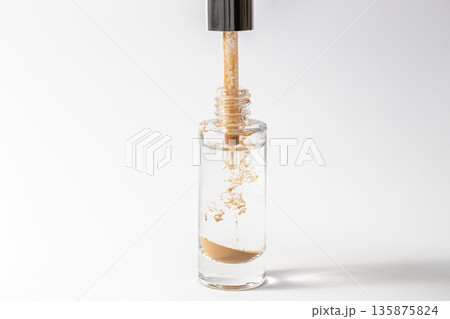 Liquid facial skin care product on a white background isolated. Liquid facial skin care product on a white background isolated. 135875824
