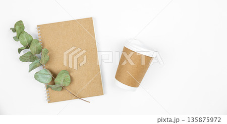 Paper disposable cup and notepad made from recycled paper cups, top view. 135875972