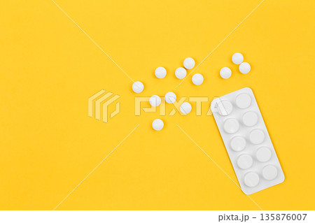 Pills on yellow background, flat lay, conceptual minimalism. Pills on yellow background, flat lay, conceptual minimalism. 135876007
