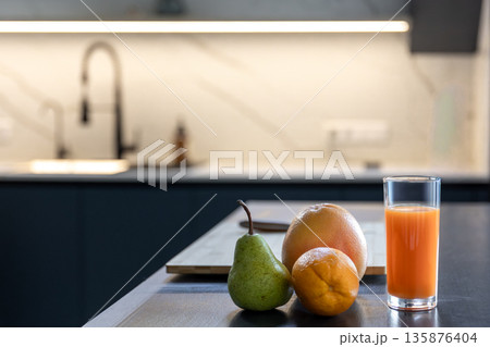 Fresh set in home kitchen near board and knife. Orange juice. Fresh set in home kitchen near board and knife. Orange juice. 135876404