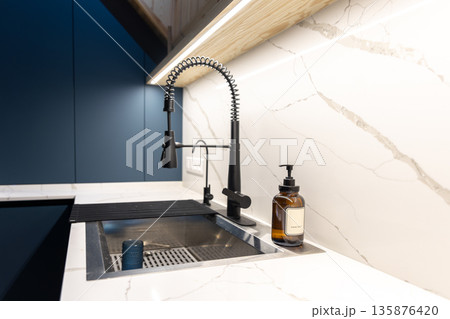 Modern sink. Black faucet. Marble countertop. 135876420
