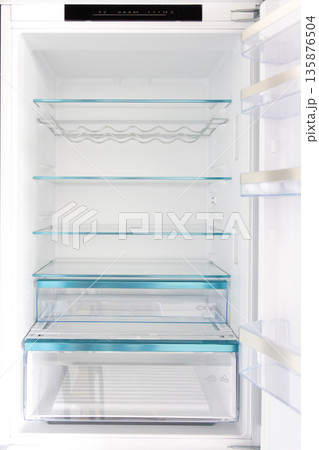Empty fridge interior. Glass shelves. Clean minimalism Empty fridge interior. Glass shelves. Clean minimalism 135876504
