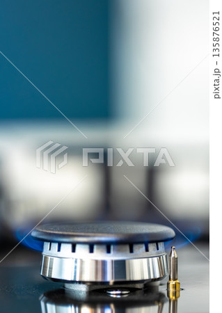 Gas burner macro. Blue flame. Modern cooktop Gas burner macro. Blue flame. Modern cooktop 135876521