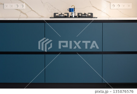 Minimalist kitchen. Blue cabinet front. Modern interior. 135876576