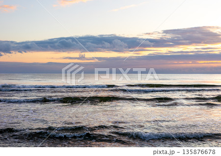 Sea waves at sunset. Evening horizon and calm. Sea waves at sunset. Evening horizon and calm. 135876678