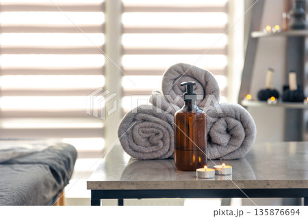 Spa towels with dispenser and candles. Modern selfcare 135876694