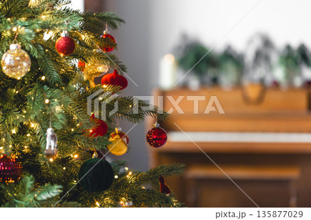 Christmas background with decorated Christmas tree and piano, copy space. Christmas background with decorated Christmas tree and piano, copy space. 135877029