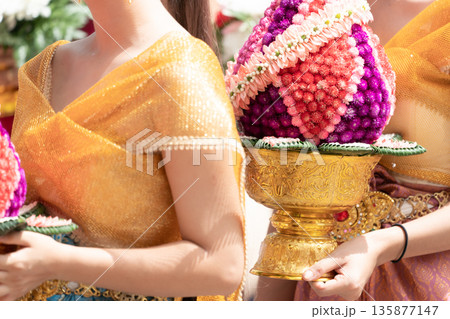 Close up hand of Thai folk dance during celebration on temple background. Thai traditional dance on event celebration. Close up hand of Thai folk dance during celebration on temple background. Thai traditional dance on event celebration. 135877147