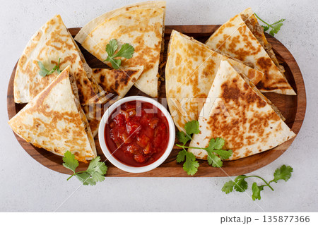 Ground turkey and cheddar quesadillas with salsa 135877366