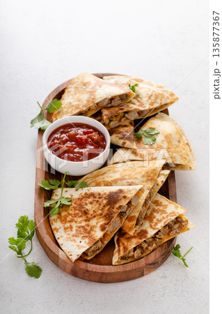 Ground turkey and cheddar quesadillas with salsa 135877367
