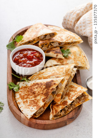 Ground turkey and cheddar quesadillas with salsa 135877370