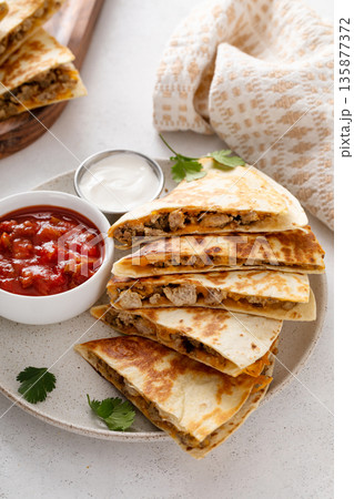 Ground turkey and cheddar quesadillas with salsa 135877372