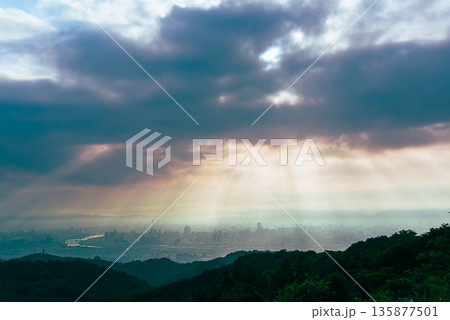 Cityscape Dawn Rays Dadao Mountain Taiwan - Ethereal Sunbeams Through Pink Haze. Cityscape Dawn Rays Dadao Mountain Taiwan - Ethereal Sunbeams Through Pink Haze. 135877501
