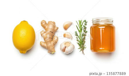 Fresh lemon, ginger root, garlic cloves, rosemary sprigs, and honey jar arranged on a white background, showcasing natural ingredients for healthy cooking and wellness 135877889