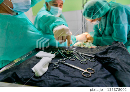 Surgical Team in Operating Room Preparing Sterile Instruments for a Critical Operation in Hospital 135878002