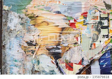 Abstract torn paper collage with layered posters and peeling paint forming colorful textured surface. Urban creativity, raw artistic background 135879818