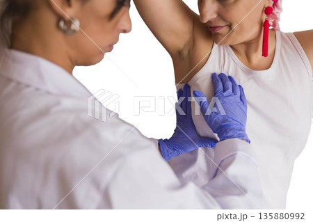 Doctor performing breast examination detecting breast cancer early Doctor performing breast examination detecting breast cancer early 135880992