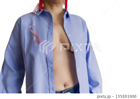 Woman wearing pink ribbon for breast cancer awareness 135881000