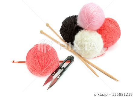 Colorful yarn balls with knitting needles and crochet hook isolated on white. Colorful yarn balls with knitting needles and crochet hook isolated on white. 135881219