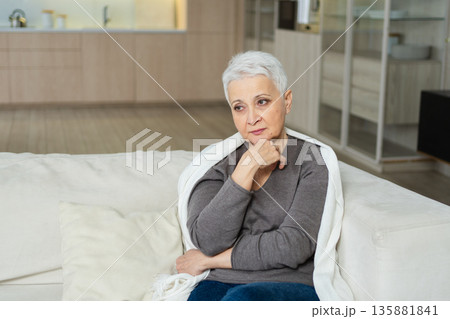 Sad tired ill sick lonely disappointed older senior woman sitting at home alone. Unhappy mature grandmother experiencing grief relative death bad news. Stressed elder lady suffering from loneliness 135881841