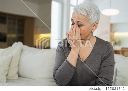Sad tired ill sick lonely disappointed older senior woman sitting at home alone. Unhappy mature grandmother experiencing grief relative death bad news. Stressed elder lady suffering from loneliness 135881842