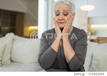 Sad tired ill sick lonely disappointed older senior woman sitting at home alone. Unhappy mature grandmother experiencing grief relative death bad news. Stressed elder lady suffering from loneliness 135881844