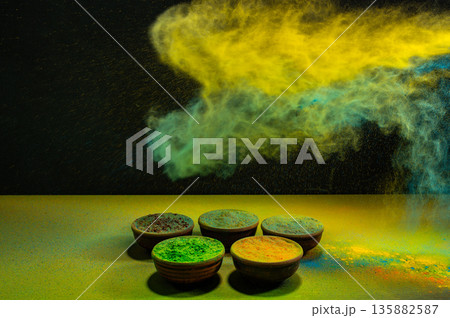 colorful rainbow holi paint color powder explosion isolated on dark black background. colorful rainbow holi paint color powder explosion isolated on dark black background. 135882587