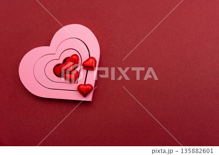 Pink Heart Shapes on Red Background with Copy Space Valentines Day Love Concept Pink Heart Shapes on Red Background with Copy Space Valentines Day Love Concept 135882601