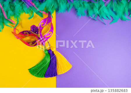 Vibrant Mardi Gras background with mask, beads, and festive decorations Vibrant Mardi Gras background with mask, beads, and festive decorations 135882683