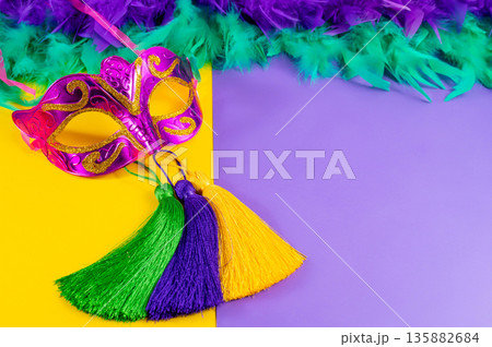 Vibrant Mardi Gras background with mask, beads, and festive decorations Vibrant Mardi Gras background with mask, beads, and festive decorations 135882684