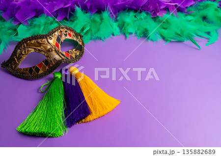 Vibrant Mardi Gras background with mask, beads, and festive decorations 135882689