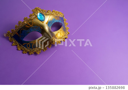 Vibrant Mardi Gras background with mask, beads, and festive decorations 135882698