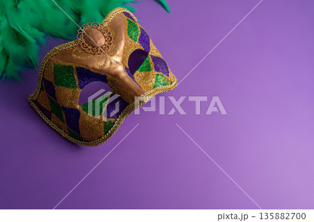Vibrant Mardi Gras background with mask, beads, and festive decorations Vibrant Mardi Gras background with mask, beads, and festive decorations 135882700