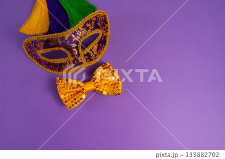 Vibrant Mardi Gras background with mask, beads, and festive decorations Vibrant Mardi Gras background with mask, beads, and festive decorations 135882702