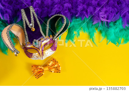 Vibrant Mardi Gras background with mask, beads, and festive decorations 135882703
