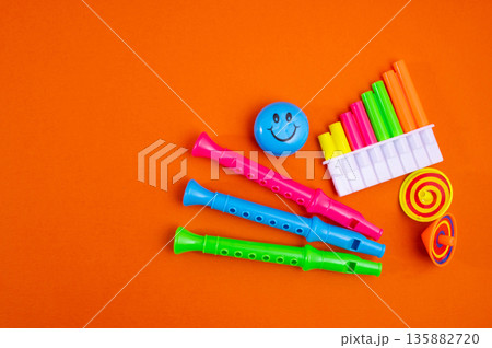 Calendar with clown wig, funny glasses and sequins on brown background. April Fools Day 135882720