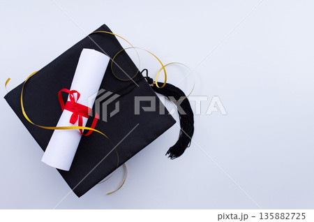 A symbolic representation of global education, graduation. graduation cap, books, globe and diploma on a colorful background. 135882725