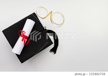 A symbolic representation of global education, graduation. graduation cap, books, globe and diploma on a colorful background. 135882726