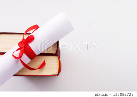 A symbolic representation of global education, graduation. graduation cap, books, globe and diploma on a colorful background. A symbolic representation of global education, graduation. graduation cap, books, globe and diploma on a colorful background. 135882728