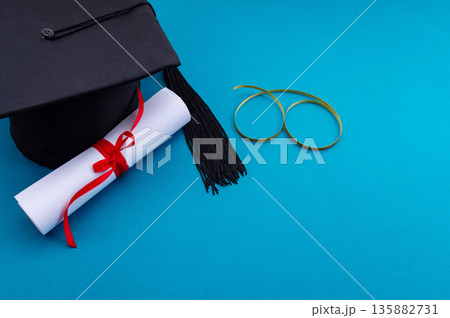 A symbolic representation of global education, graduation. graduation cap, books, globe and diploma on a colorful background. 135882731