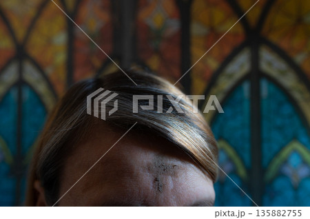 Ash Wednesday celebrations in church on stained glass window. Ash Wednesday celebrations in church on stained glass window. 135882755