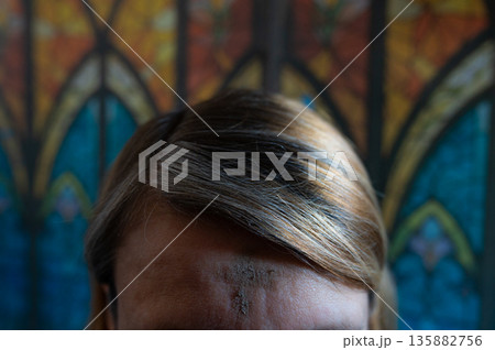 Ash Wednesday celebrations in church on stained glass window. 135882756